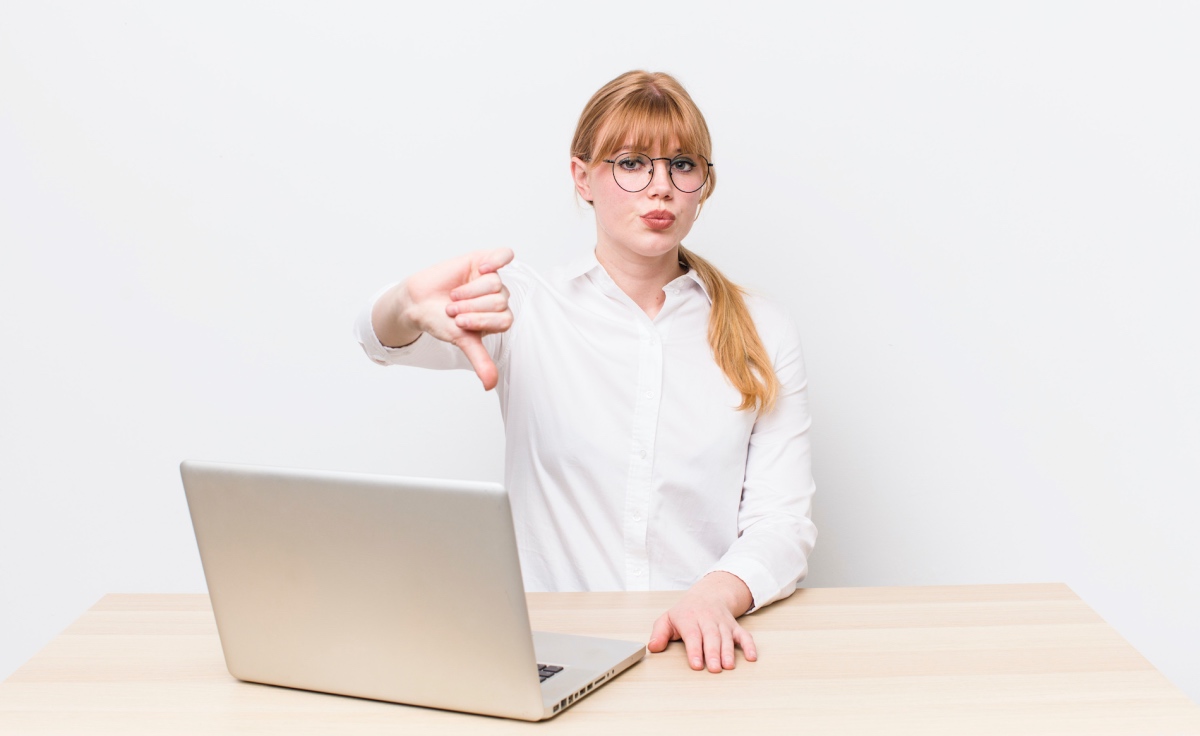 Woman Making A Thumbs Down Gesture To Show Common Web Design Mistakes To Avoid
