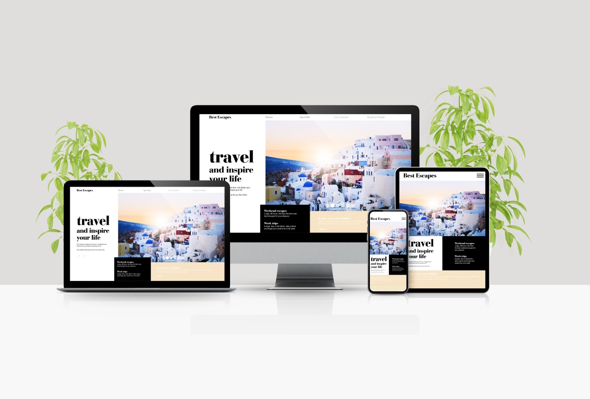 Responsive Website Design For Travel Website Shown On Laptop, Desktop, Phone, And Tablet On A White Surface With Two Plants