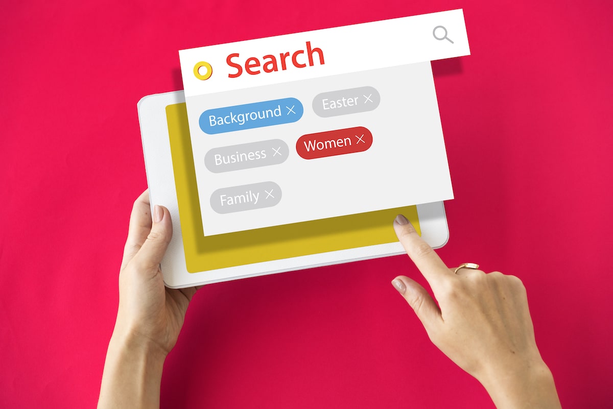 Ipad with hand on showing SEARCH on google