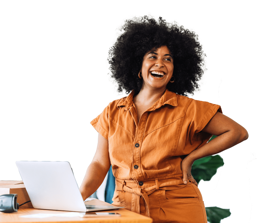 Smiling Woman Using A Laptop In A Modern Workspace – Contact Us For Expert Ecommerce Website Design Vancouver.
