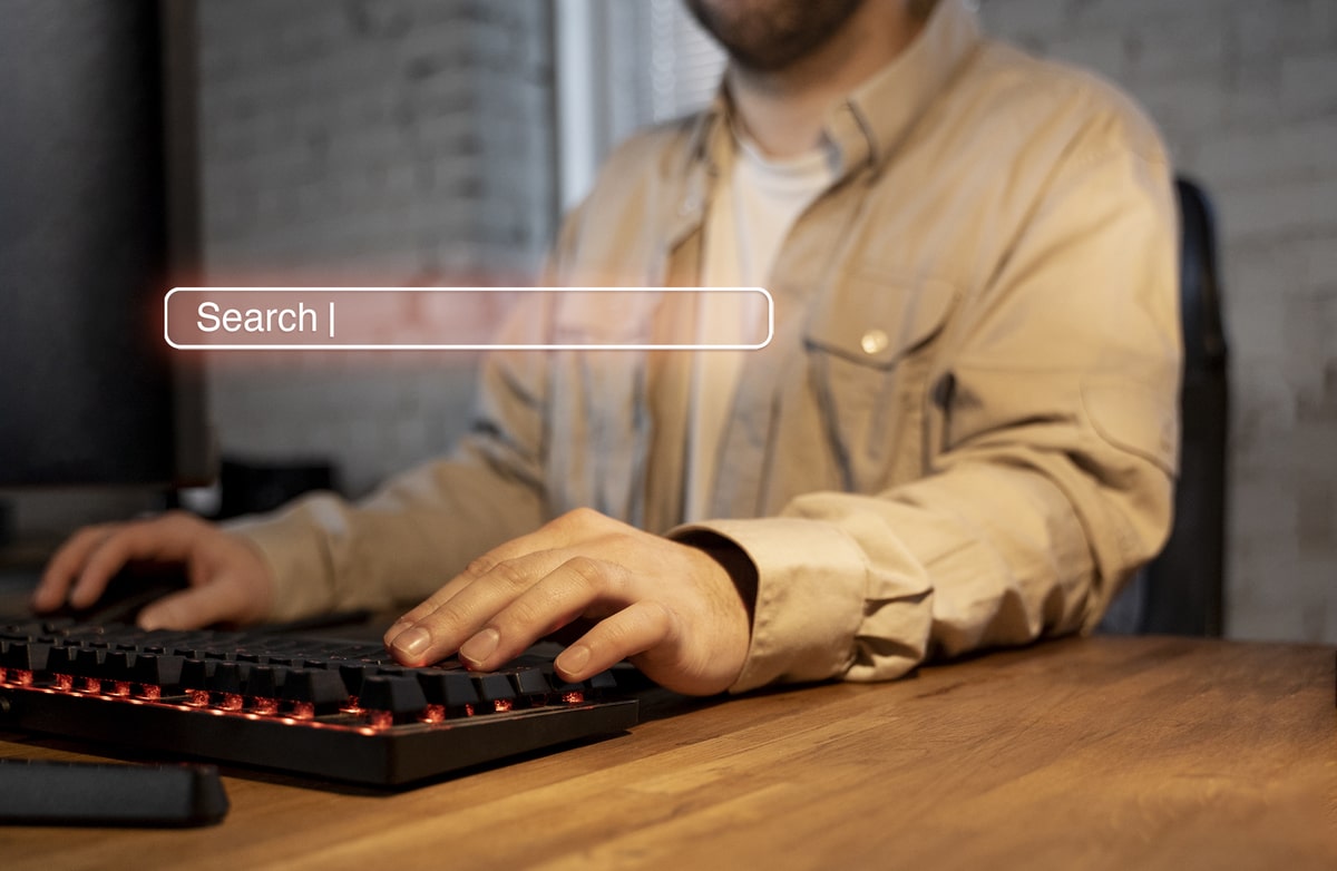 Person typing on a keyboard with a digital search bar overlay, representing SEO search intent