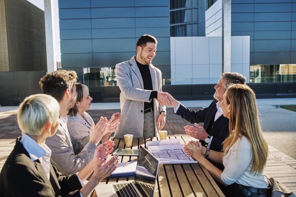 Business deal closing successfully, highlighting the trust clients gain with professional websites instead of DIY sites
