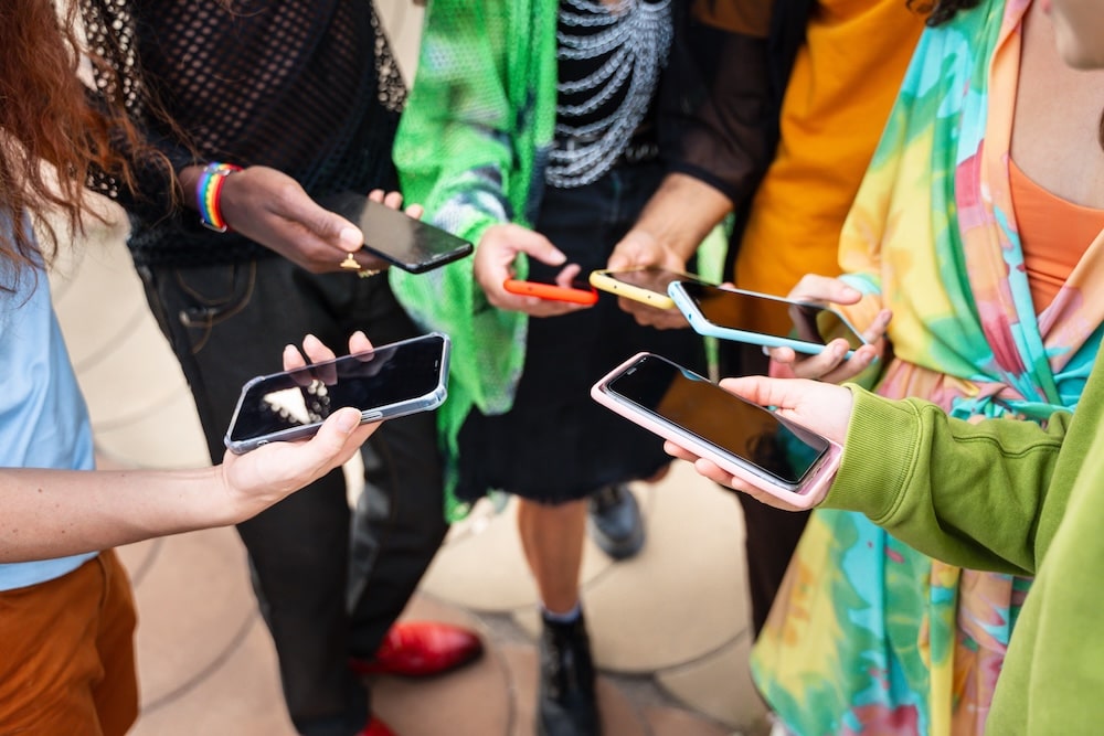 People comparing websites on mobile phones, showing how DIY websites kill client confidence with poor mobile experience